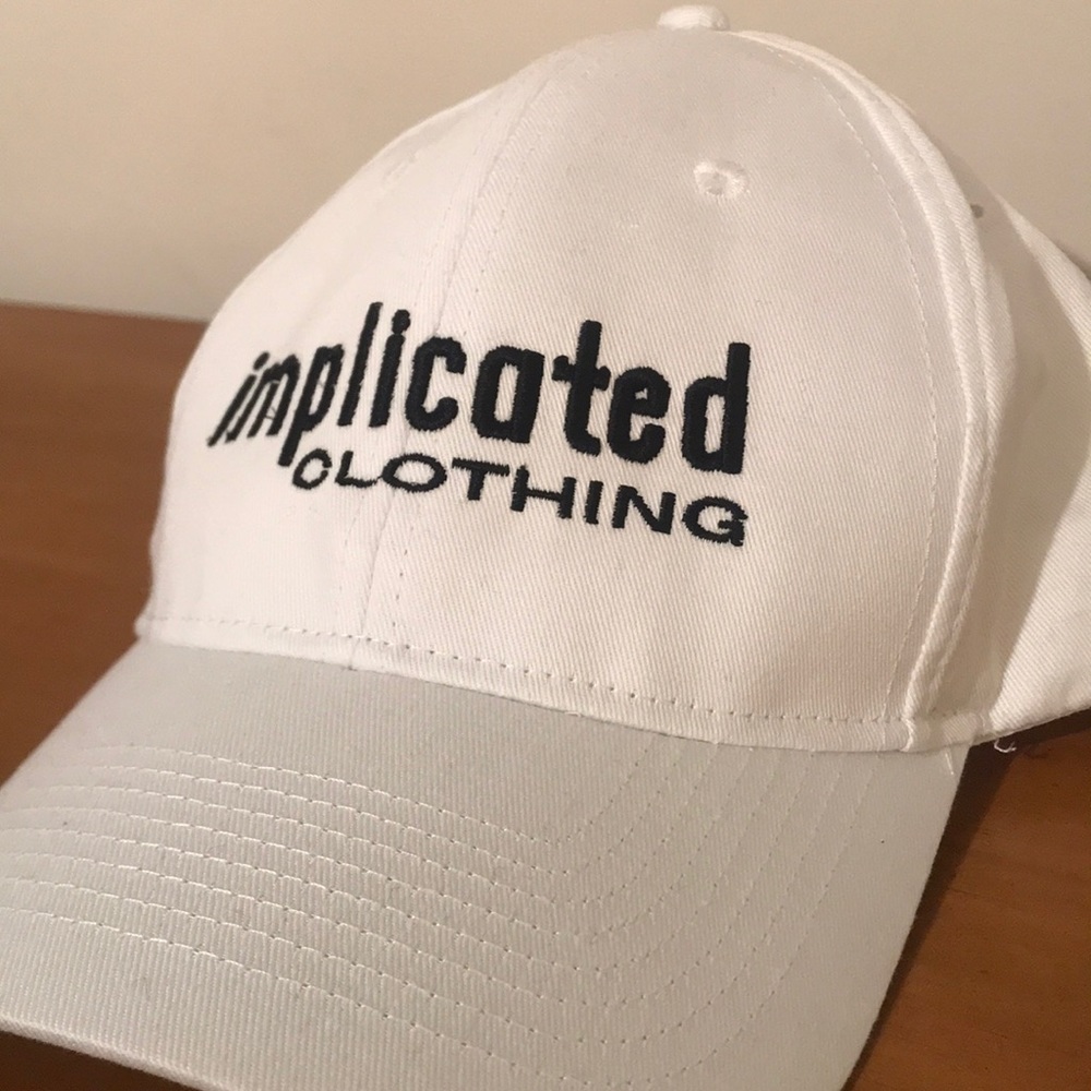 White “Implicated Clothing” dad hat